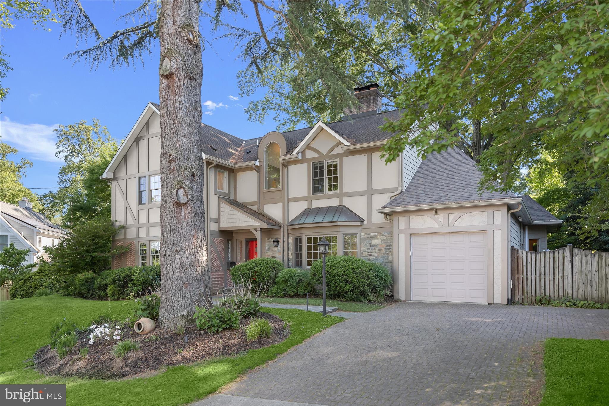 5104 Scarsdale Road Bethesda, MD 20816 - Photo 2 of 68 a front view of a house with a garden and tree