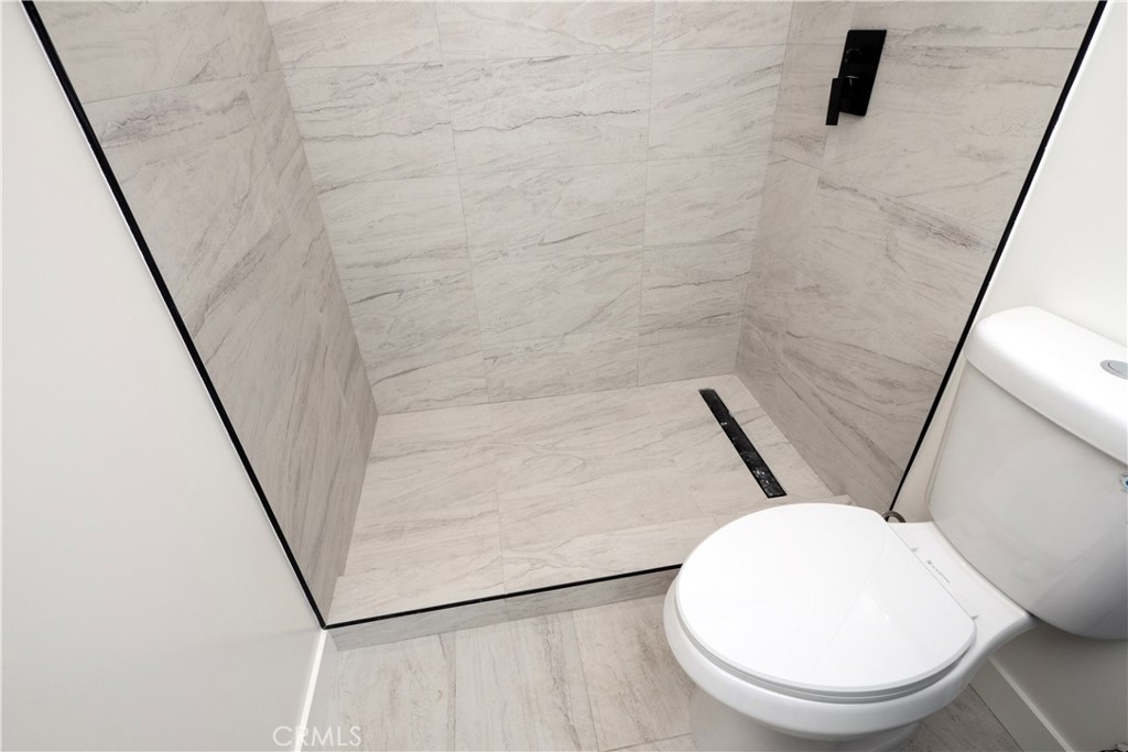 1571 Ricardo Street Los Angeles, CA 90033 - Photo 27 of 29 a bathroom with a toilet and a mirror