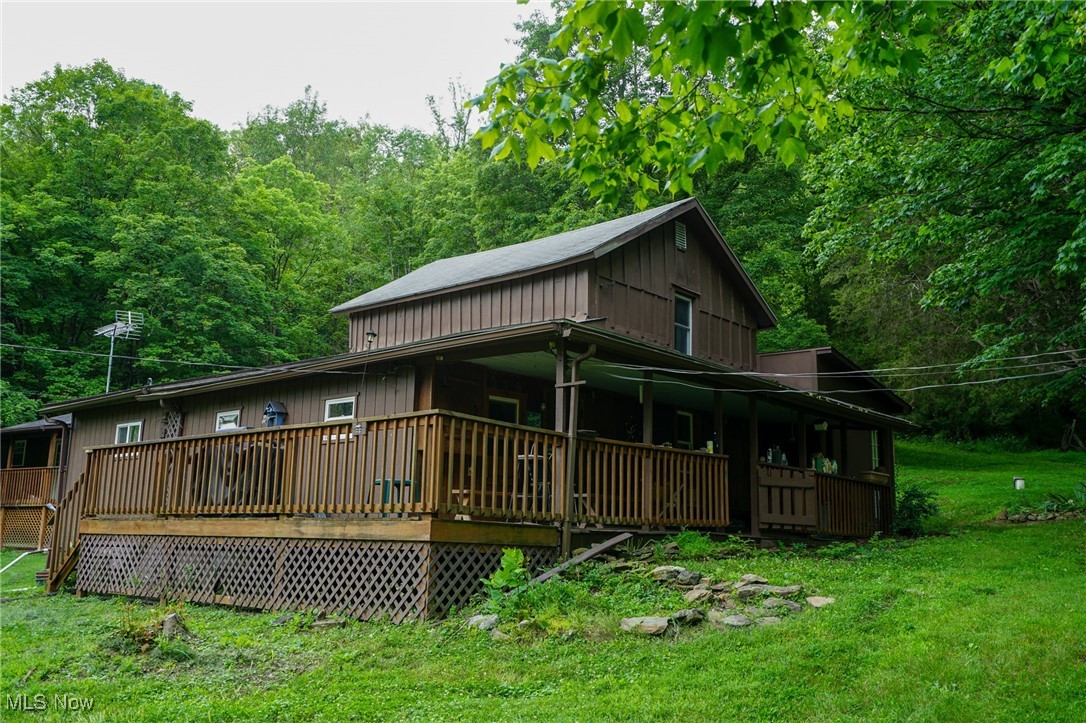 34799 Paw Road Lower Salem, OH 45745 - Photo 2 of 50 Rear view of house with a lawn, covered porch, and a view of trees