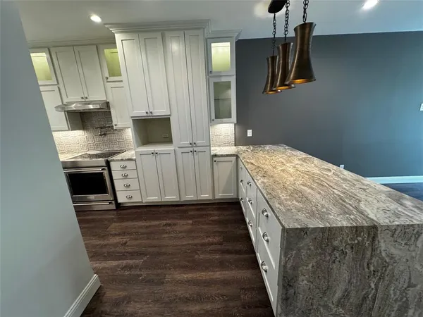 a spacious bathroom with a granite countertop sink and a mirror