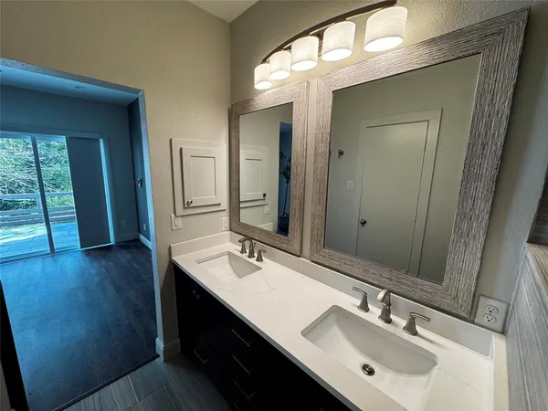 a bathroom with a sink double vanity and a mirror