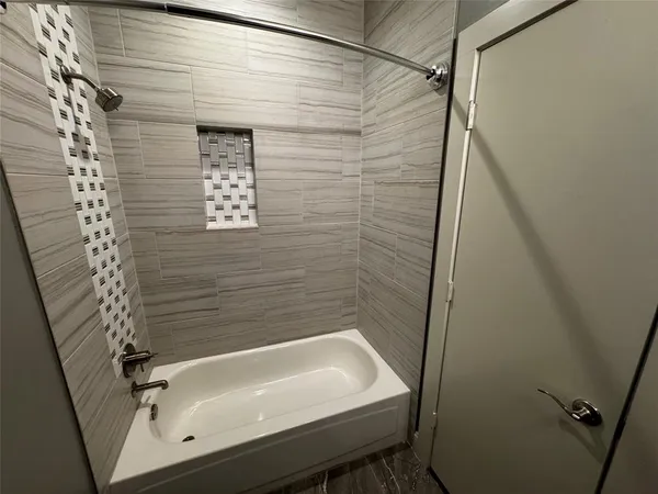 a bathroom with a tub and a shower
