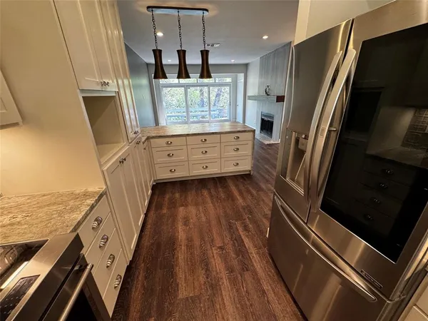 a view of a kitchen with a sink and wooden floor