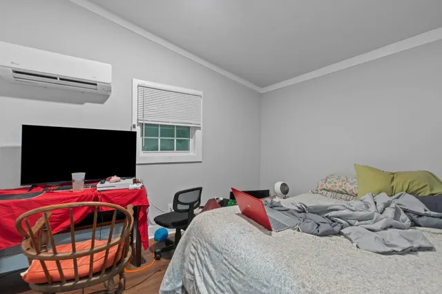 a bedroom with a bed and a window