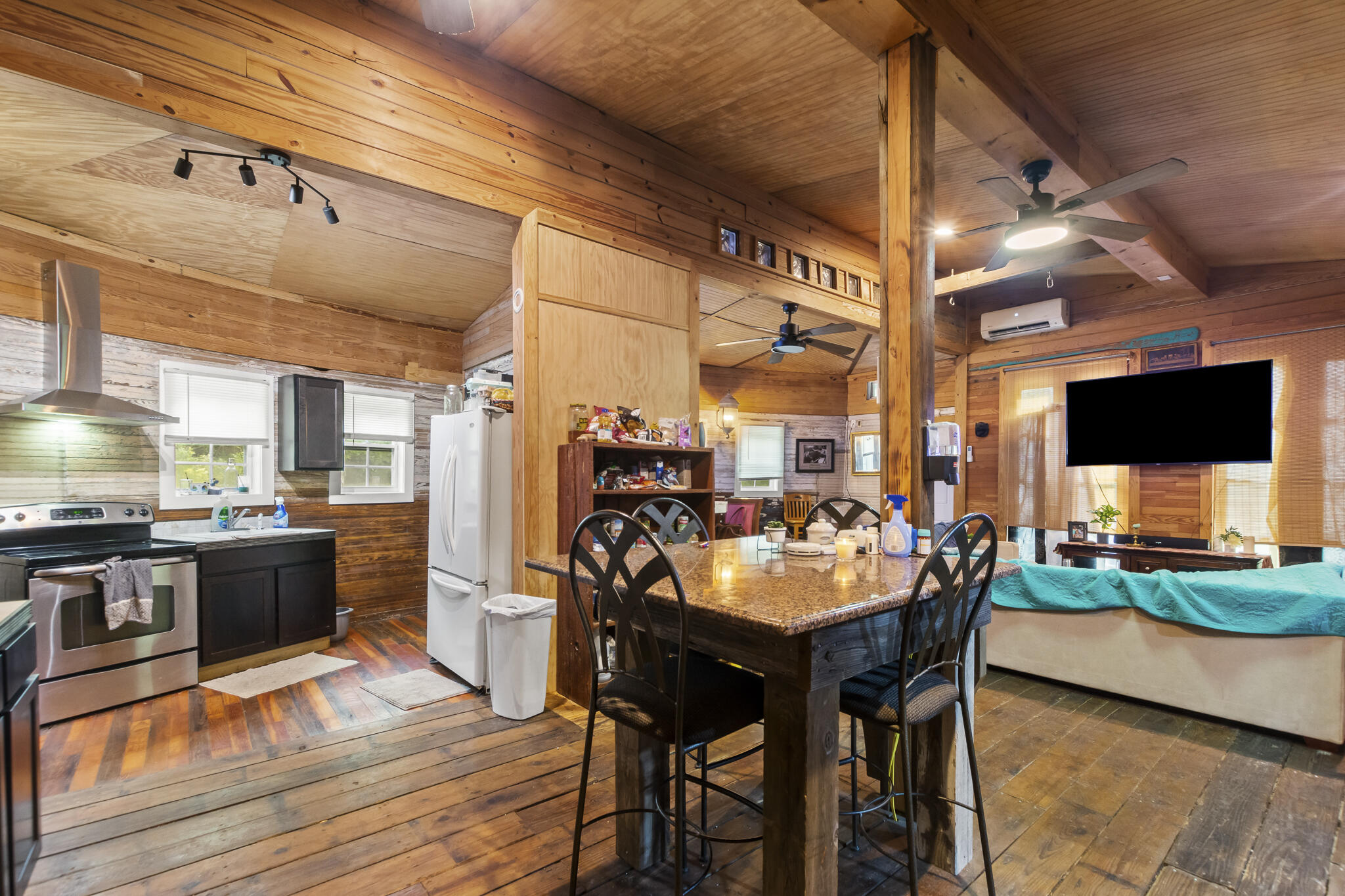 74 West Shell Cracker Road Freeport, FL 32439 - Photo 19 of 40 a kitchen with stainless steel appliances kitchen island granite countertop a table chairs and a stove