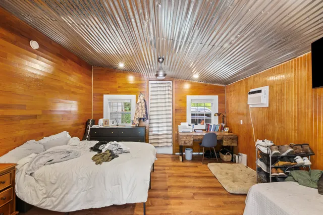a bedroom with furniture and a flat screen tv
