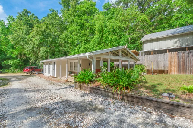 a view of a patio with table and chairs wooden floor and fence