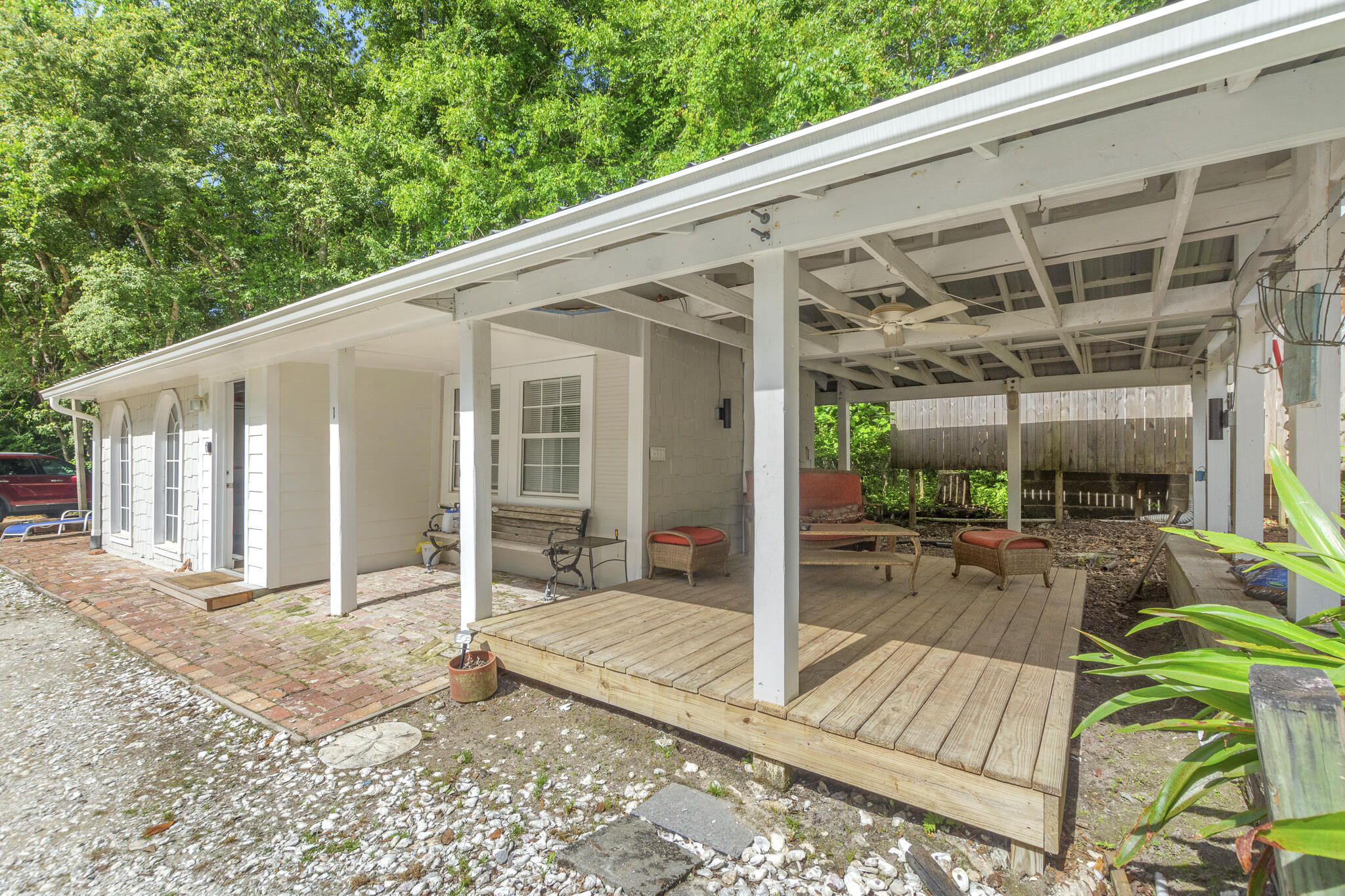 74 West Shell Cracker Road Freeport, FL 32439 - Photo 32 of 40 a view of a patio with table and chairs wooden floor and fence