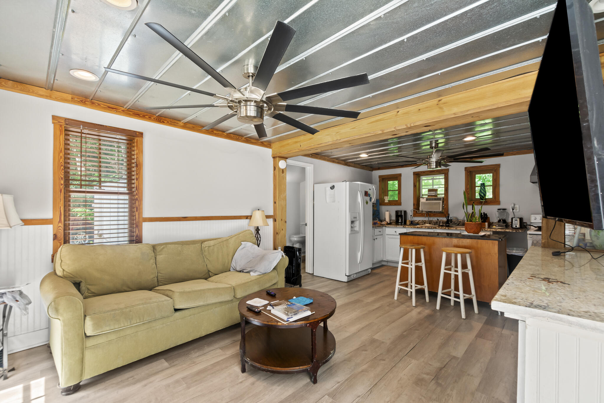 74 West Shell Cracker Road Freeport, FL 32439 - Photo 34 of 40 a living room with furniture a flat screen tv and a large window