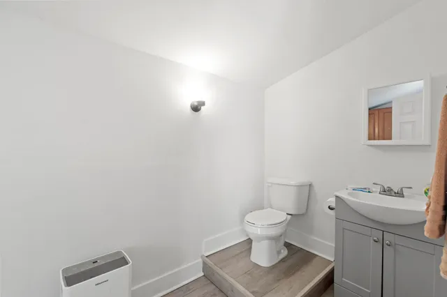 a bedroom with a bed and a wooden floor