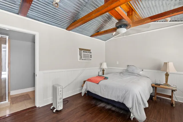 a bedroom with a bed and a large window