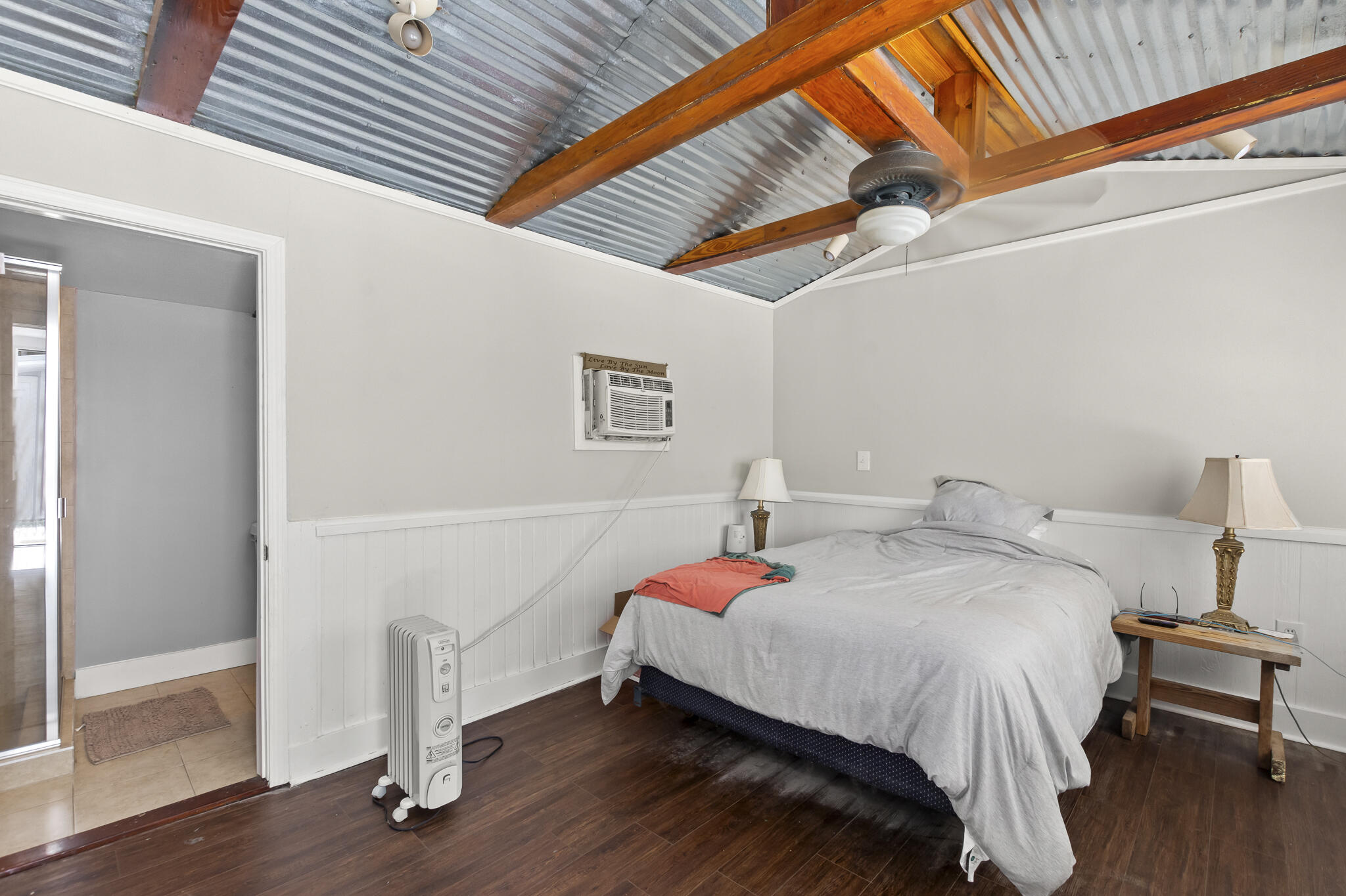 74 West Shell Cracker Road Freeport, FL 32439 - Photo 36 of 40 a bedroom with a bed and a wooden floor