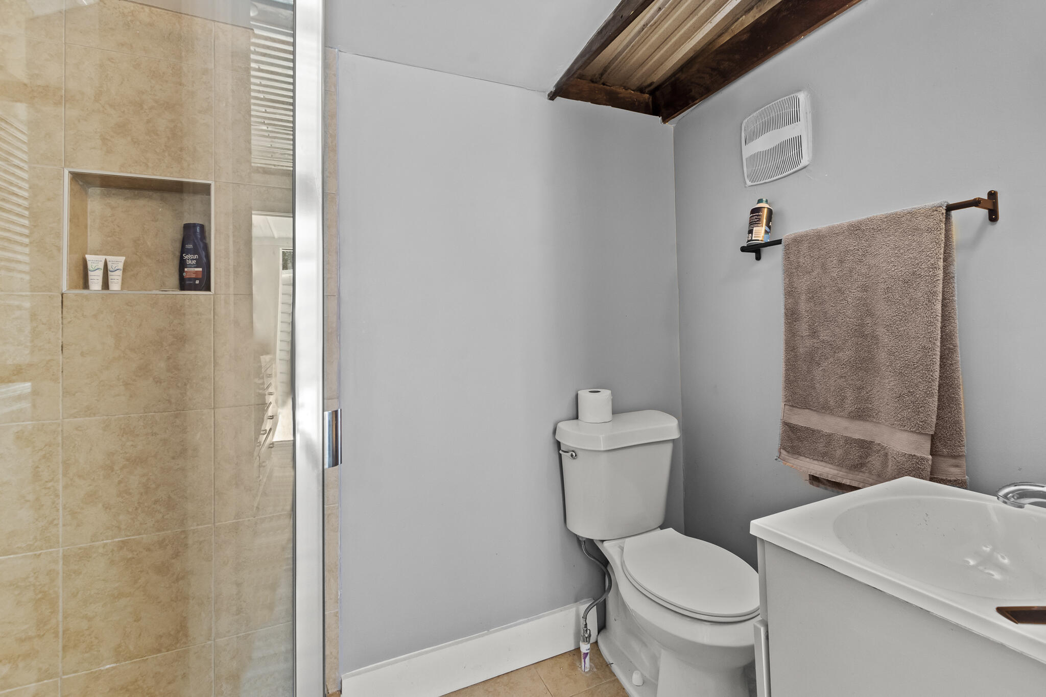 74 West Shell Cracker Road Freeport, FL 32439 - Photo 38 of 40 a white toilet sitting next to a bathroom sink and vanity