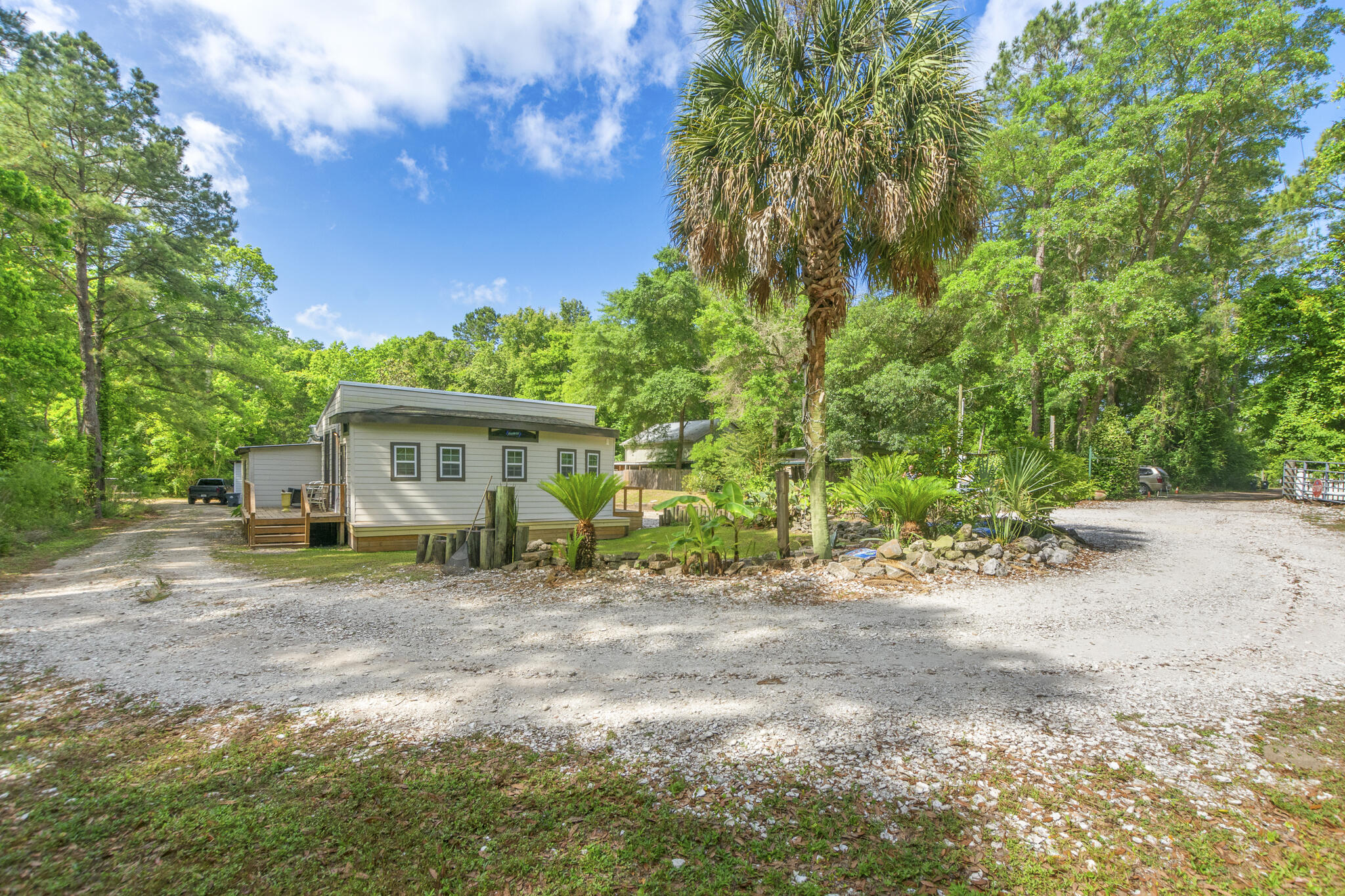 74 West Shell Cracker Road Freeport, FL 32439 - Photo 4 of 40 a view of a house with backyard and trees