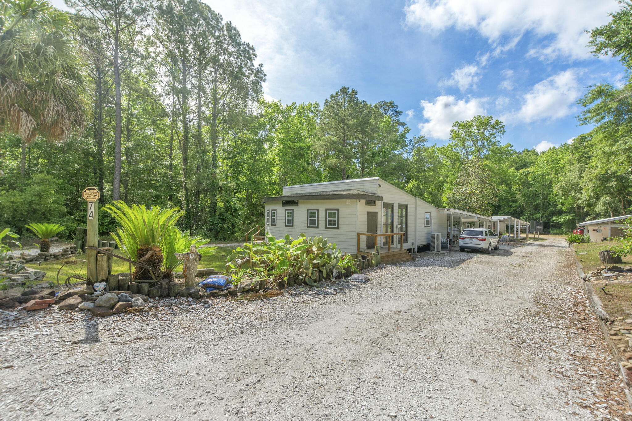 74 West Shell Cracker Road Freeport, FL 32439 - Photo 6 of 40 a view of a house with a yard and sitting area