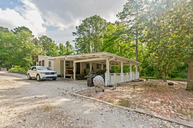 a view of a house with backyard space and sitting area