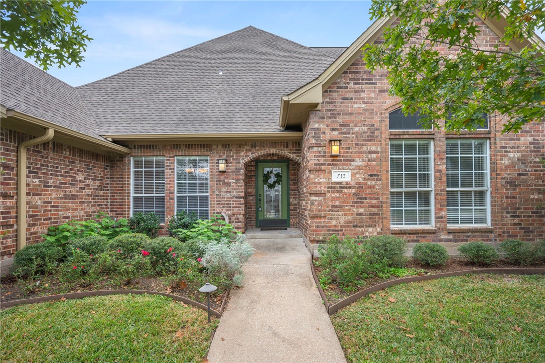 713 Willow Loop College Station, TX 77845 - Photo 2 of 39 a front view of a house with garden