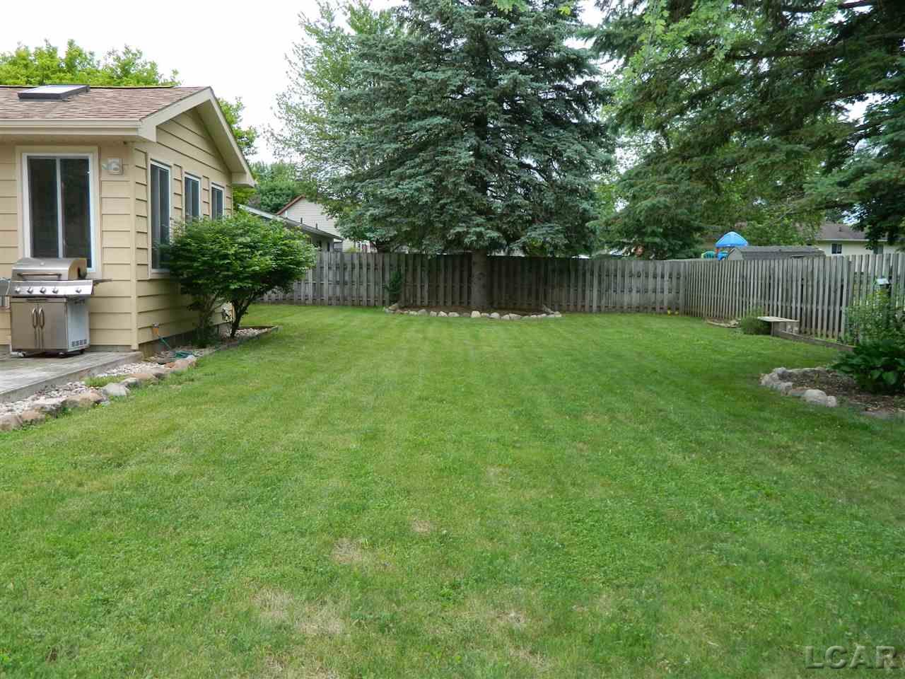 2689 West Russell Road Tecumseh, MI 49286 - Photo 25 of 28 Enjoy the beautiful back yard that has privacy fencing all the way around, nicely landscaped, mature trees, etc.