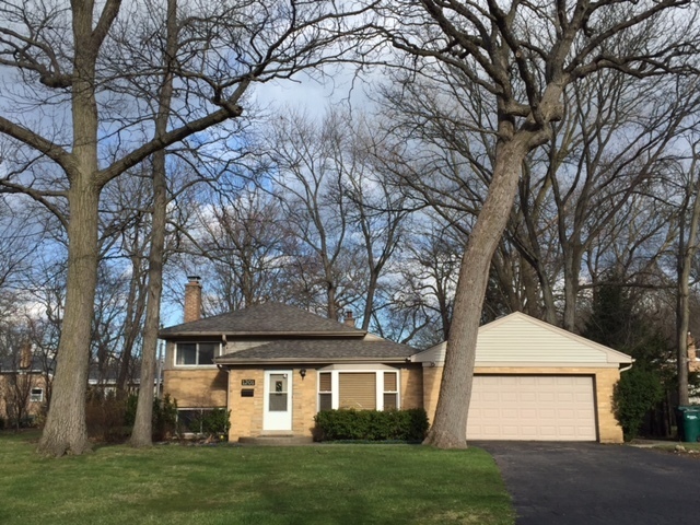 1201 Daryl Lane Northbrook, IL 60062 - Photo 1 of 15 a front view of a house with a garden and trees