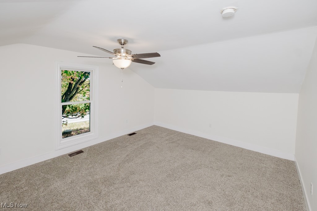 8150 Madison Road Thompson, OH 44086 - Photo 20 of 28 Bedroom featuring vaulted ceiling, carpet, and ceiling fan
