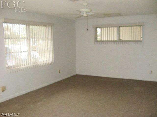 207 Davis Road Lehigh Acres, FL 33936 - Photo 2 of 10 an empty room with a window