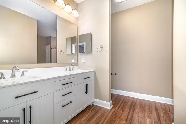a bathroom with a double vanity sink and mirror
