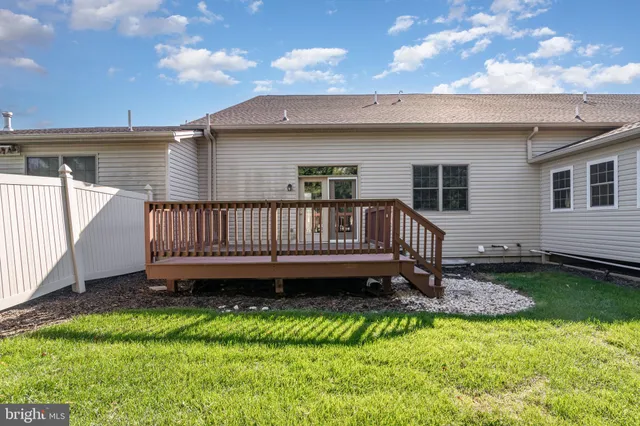 a view of a house with pool and a yard