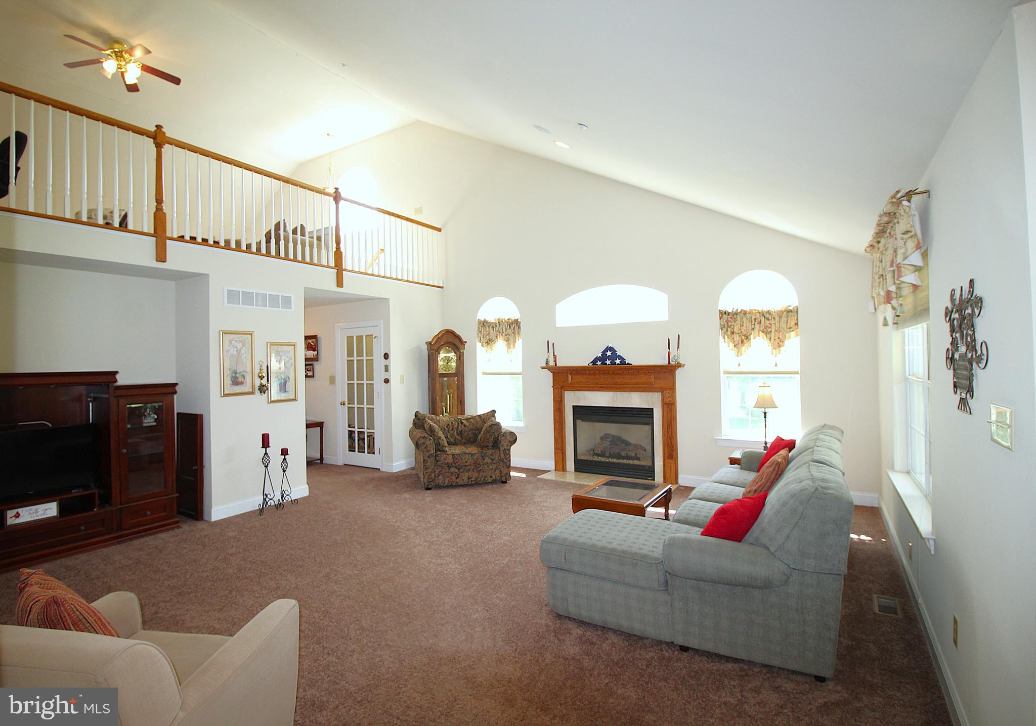 193 Curley Mill Road Chalfont, PA 18914 - Photo 33 of 49 a living room with furniture a fireplace and a chandelier