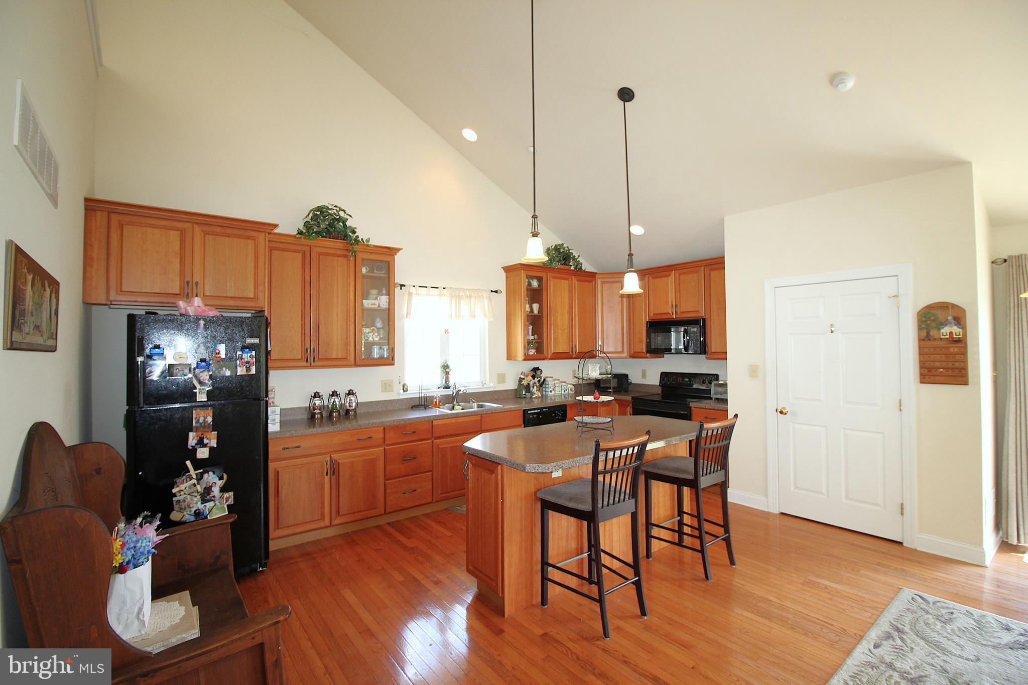 193 Curley Mill Road Chalfont, PA 18914 - Photo 36 of 49 a kitchen with stainless steel appliances a dining table chairs stove refrigerator and cabinets