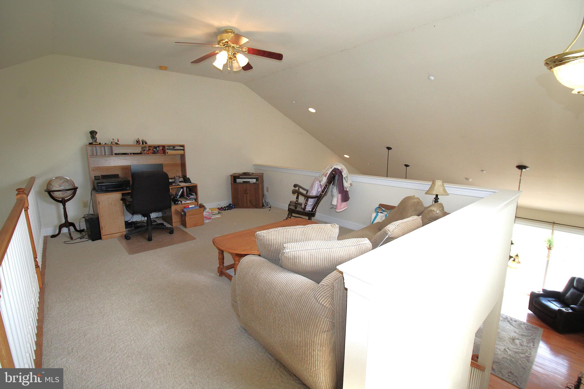 193 Curley Mill Road Chalfont, PA 18914 - Photo 40 of 49 a living room with furniture a flat screen tv and a chandelier