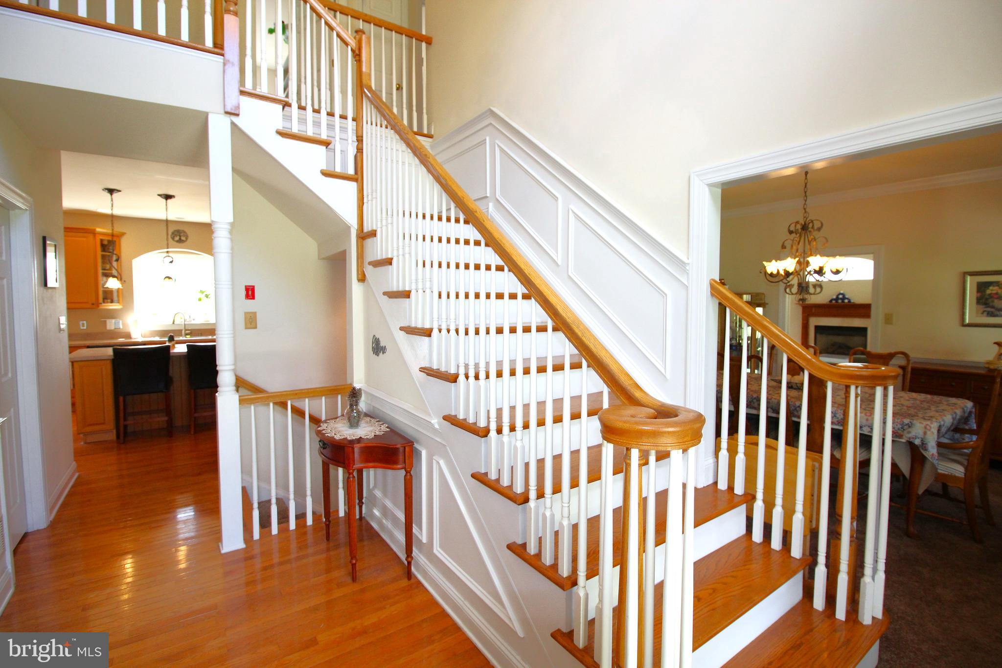 193 Curley Mill Road Chalfont, PA 18914 - Photo 6 of 49 a view of staircase with lots of frames on wall and a dining table