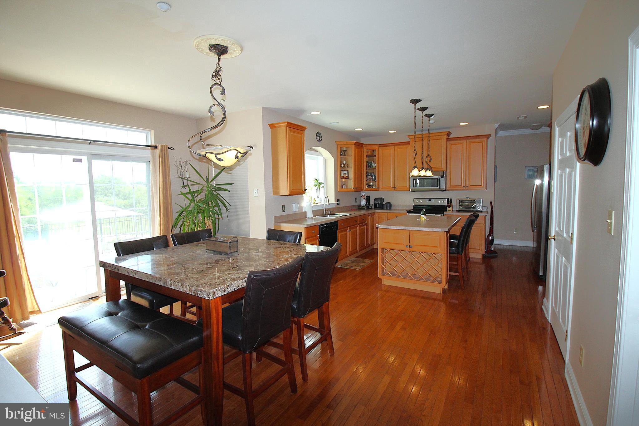 193 Curley Mill Road Chalfont, PA 18914 - Photo 7 of 49 a kitchen with a table chairs refrigerator and cabinets