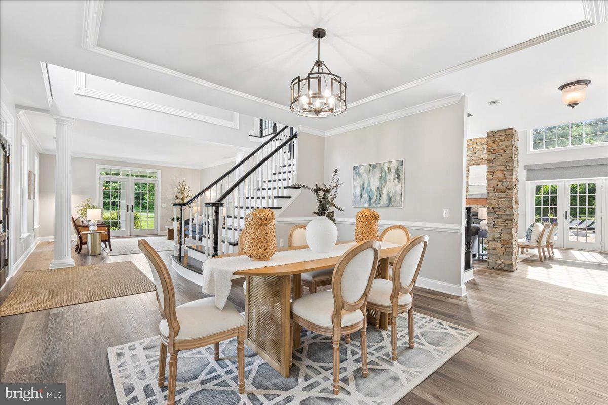 102 Little Neck Road Stevensville, MD 21666 - Photo 23 of 77 a view of a dining room with furniture wooden floor and chandelier