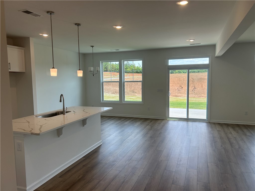 217 Bellflower Lane Anderson, SC 29625 - Photo 8 of 27 A welcoming interior offers a sleek kitchen island and immediate outdoor access.