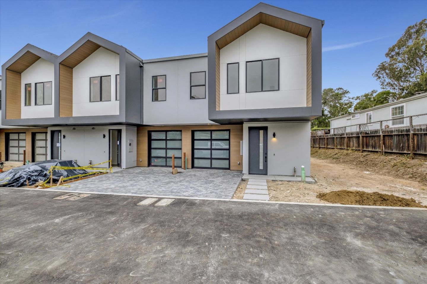 a front view of a house with a garden and potted plants