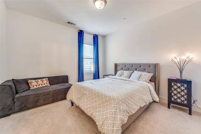 a spacious bedroom with a bed and a couch