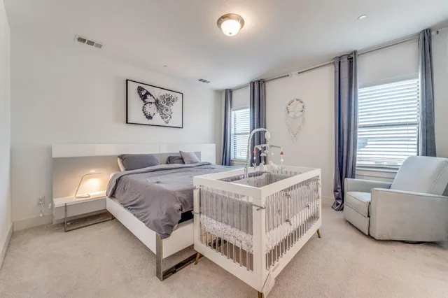 a spacious bedroom with a bed and a couch