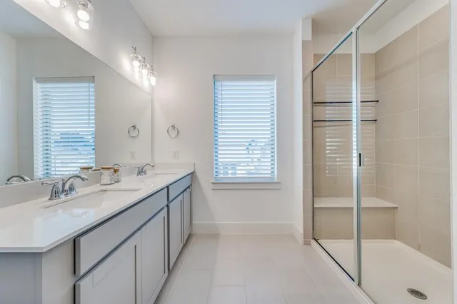 a bathroom with a granite countertop sink a mirror and a bathtub