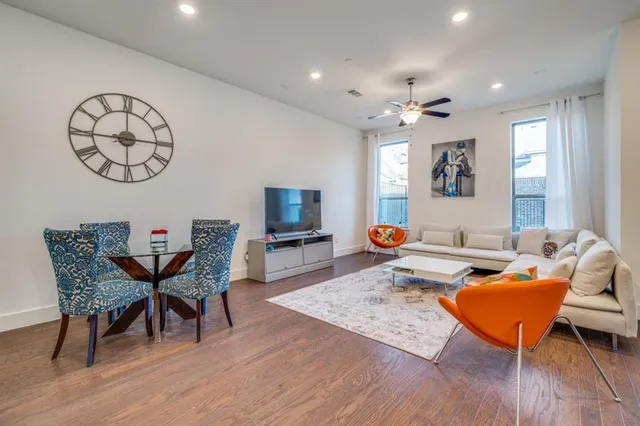 a living room with furniture a rug and a window
