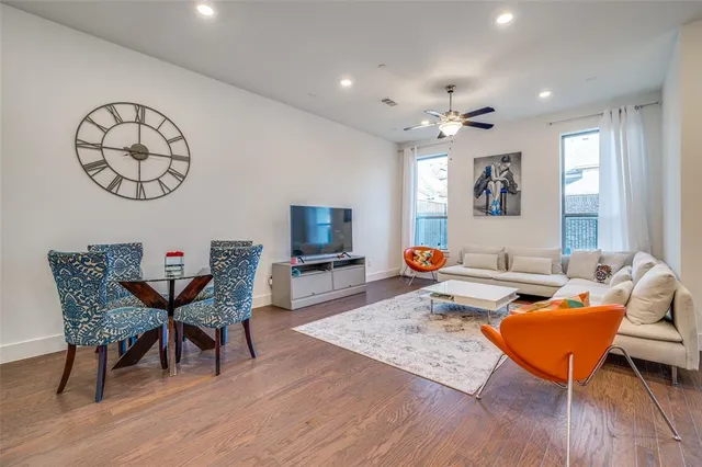 a living room with furniture a rug and a window