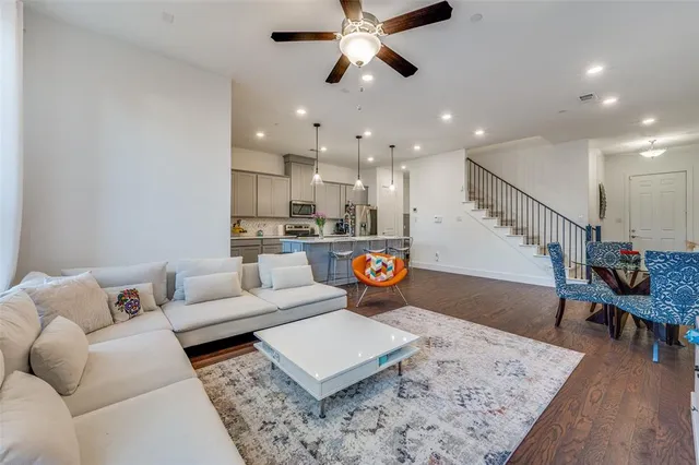 a living room with furniture and kitchen view