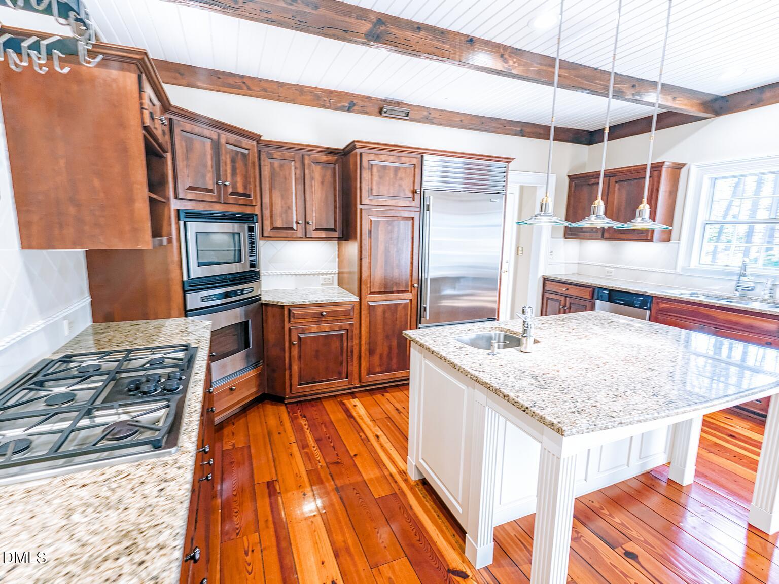 4901 Stoneridge Drive Raleigh, NC 27612 - Photo 16 of 50 a kitchen with stainless steel appliances granite countertop a sink stove and refrigerator