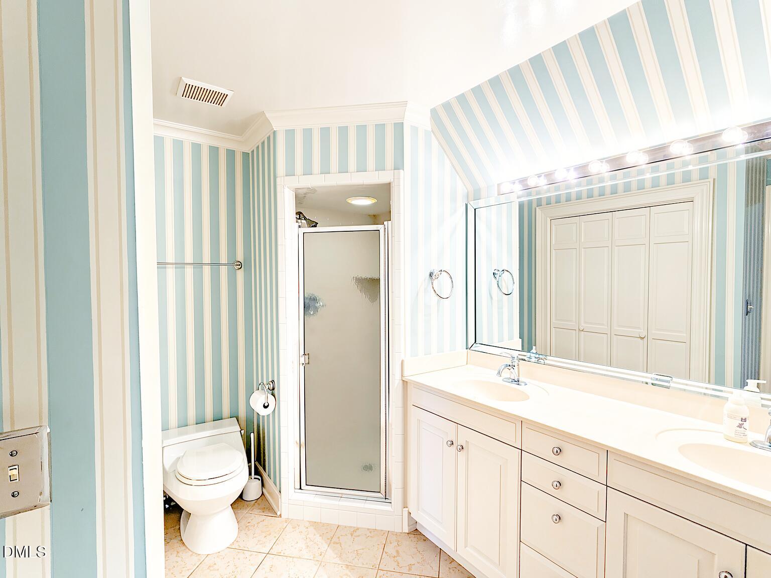 4901 Stoneridge Drive Raleigh, NC 27612 - Photo 21 of 50 a bathroom with a granite countertop sink toilet and shower