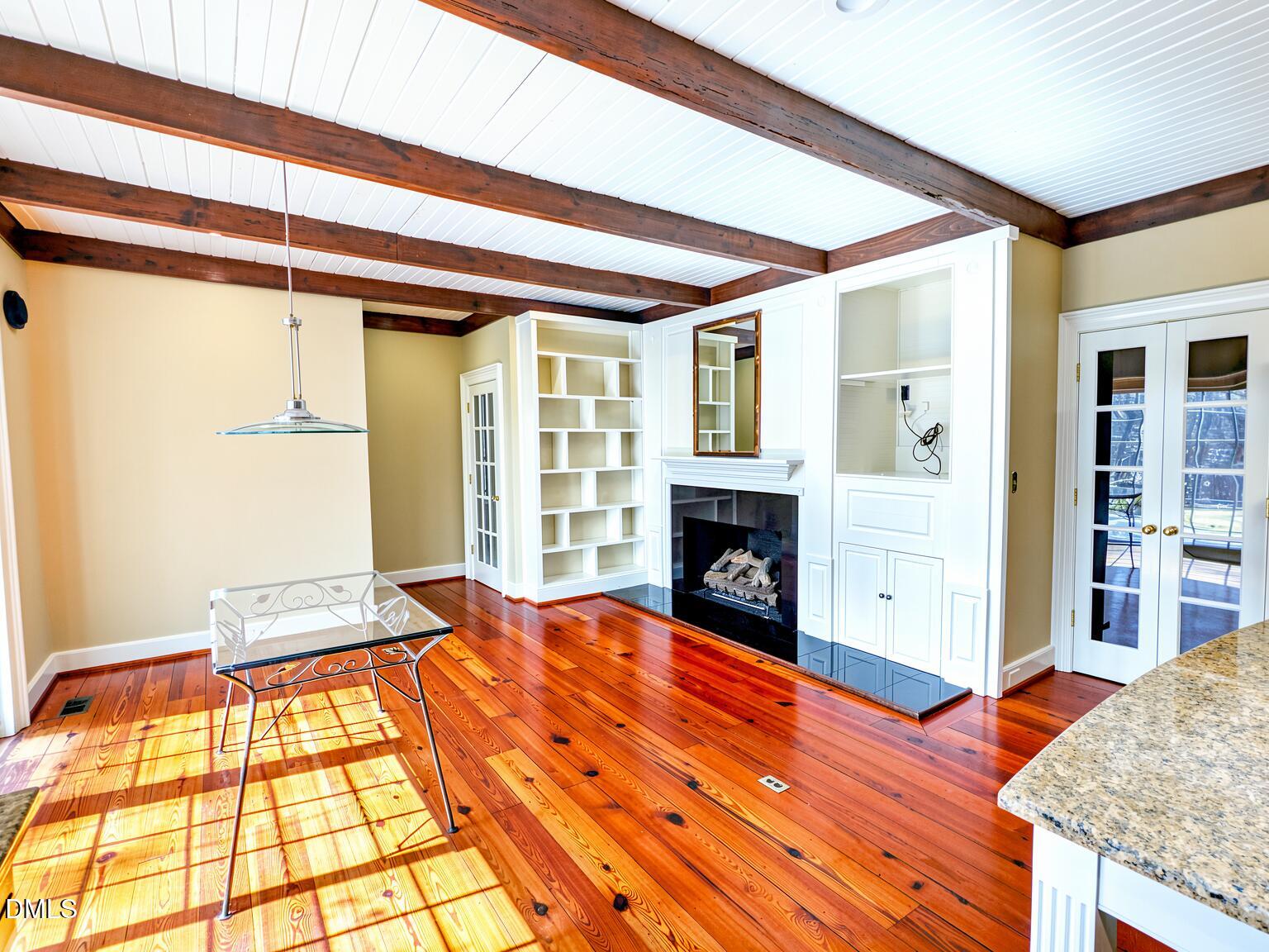 4901 Stoneridge Drive Raleigh, NC 27612 - Photo 28 of 50 a view of an empty room with wooden floor and a fireplace
