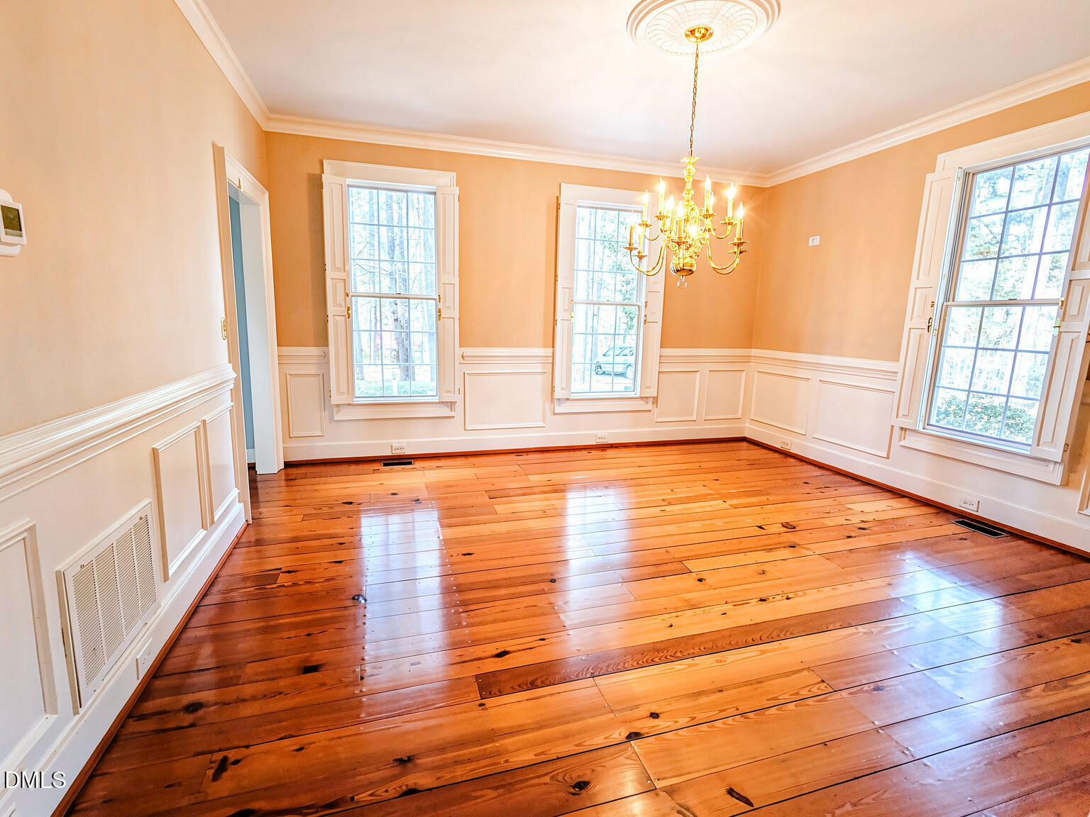 4901 Stoneridge Drive Raleigh, NC 27612 - Photo 31 of 50 a view of an empty room with wooden floor and a window