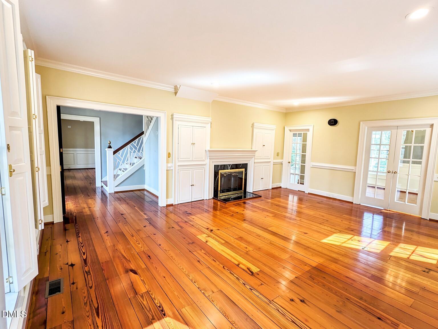 4901 Stoneridge Drive Raleigh, NC 27612 - Photo 34 of 50 a view of empty room with wooden floor and fireplace