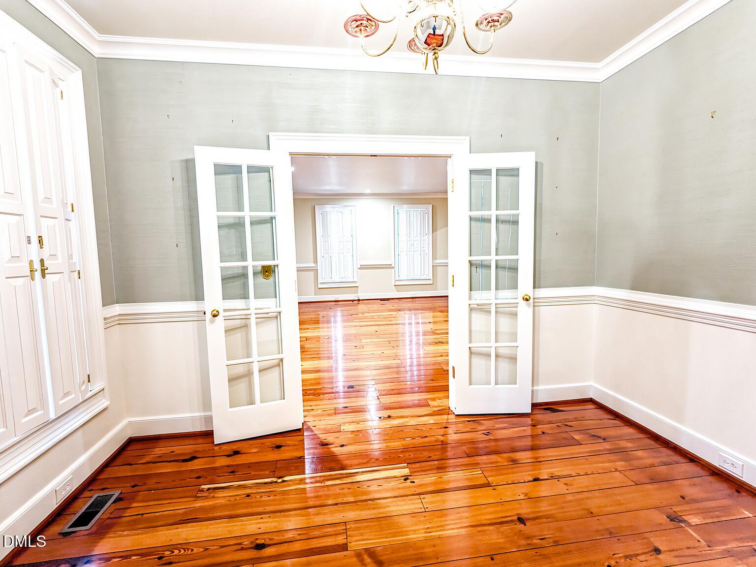 4901 Stoneridge Drive Raleigh, NC 27612 - Photo 35 of 50 a view of an empty room with wooden floor and a window