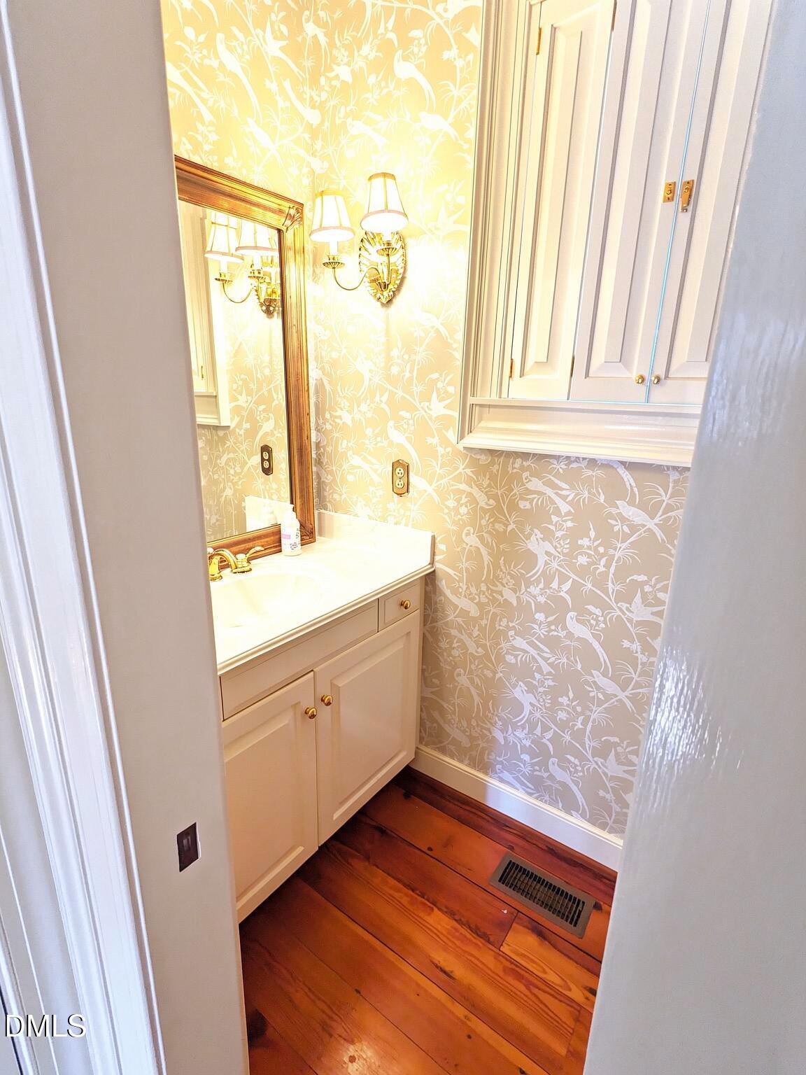 4901 Stoneridge Drive Raleigh, NC 27612 - Photo 38 of 50 a bathroom with a sink a mirror and a shower