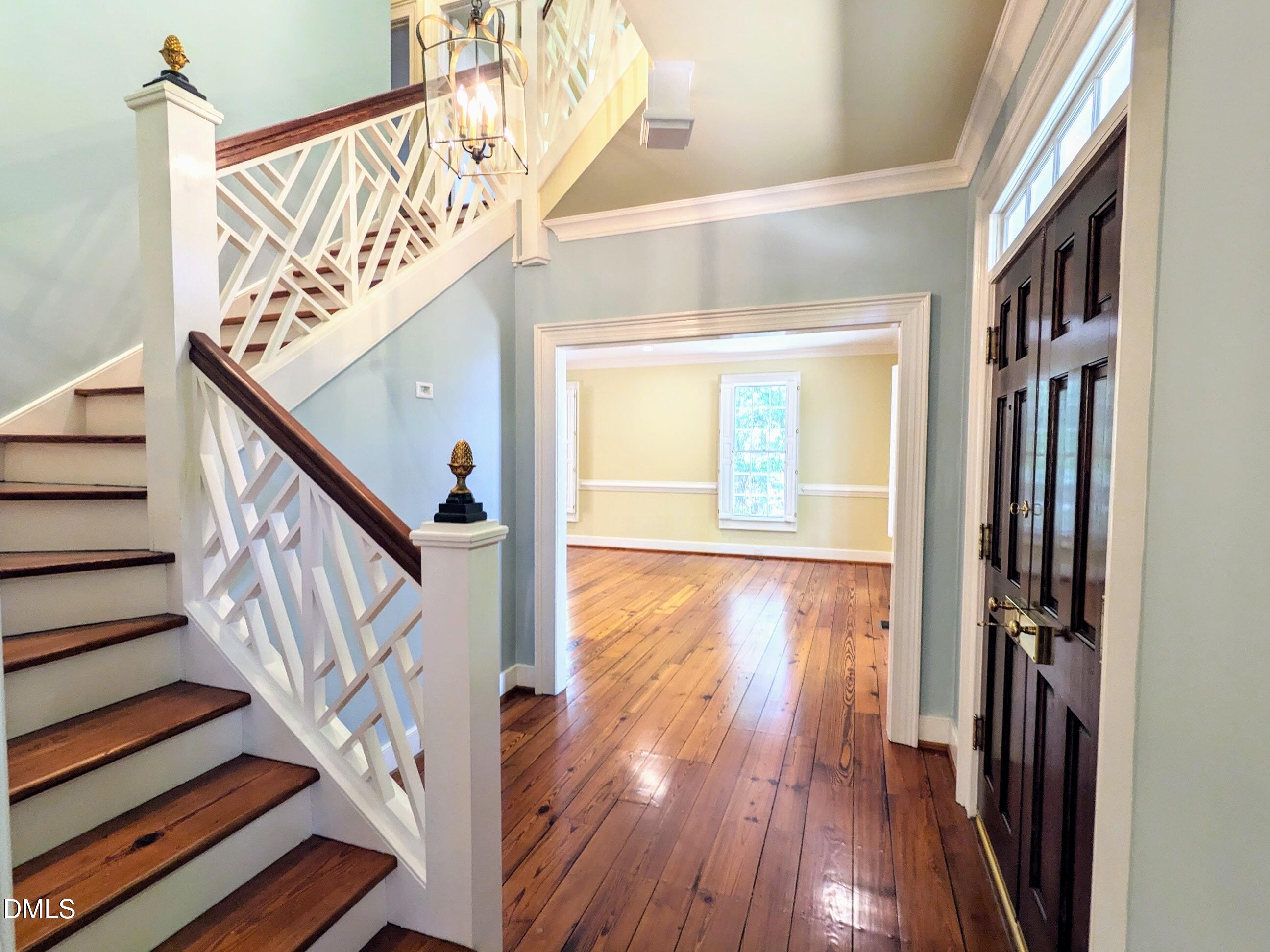 4901 Stoneridge Drive Raleigh, NC 27612 - Photo 6 of 50 a view of an entryway with wooden floor and stairs