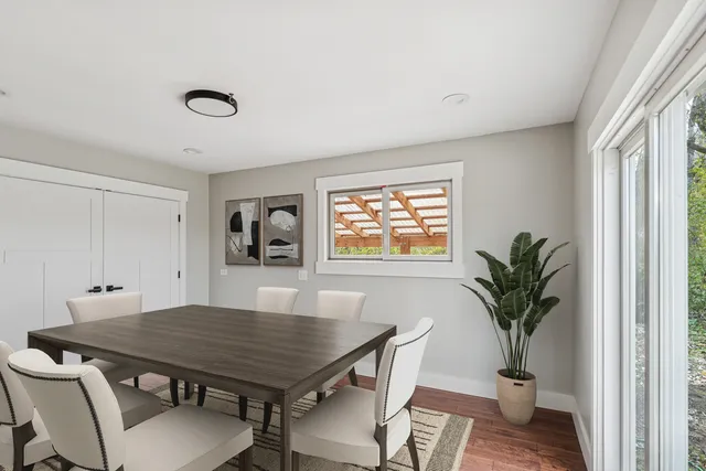 a view of a dining room with furniture and a potted plant